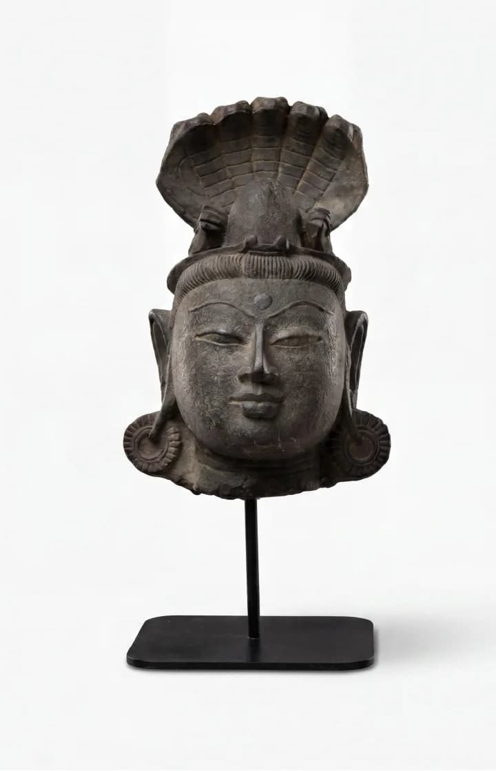 A front-facing view of the Shiva Lingam with Nandi & Serpent replica, showcasing the detailed stone-finish deity head sculpture.
