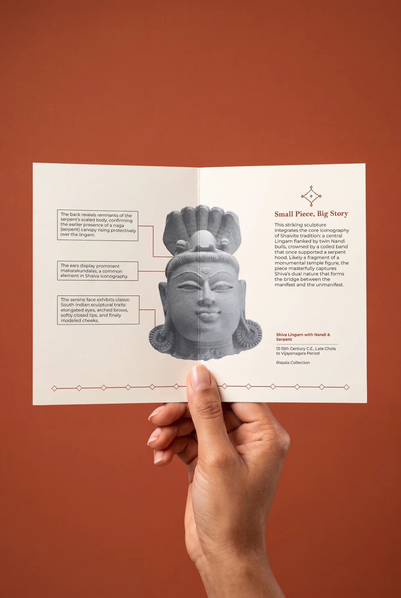 A hand holds an informational card featuring the Shiva Lingam with Nandi & Serpent replica, showcasing detailed stone-textured iconography.