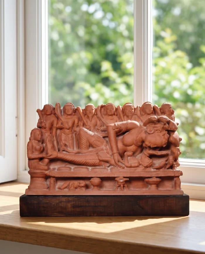 A front-view of the Krishna's Birth Sculpture, a detailed terracotta museum replica showing Devaki with her newborn child.