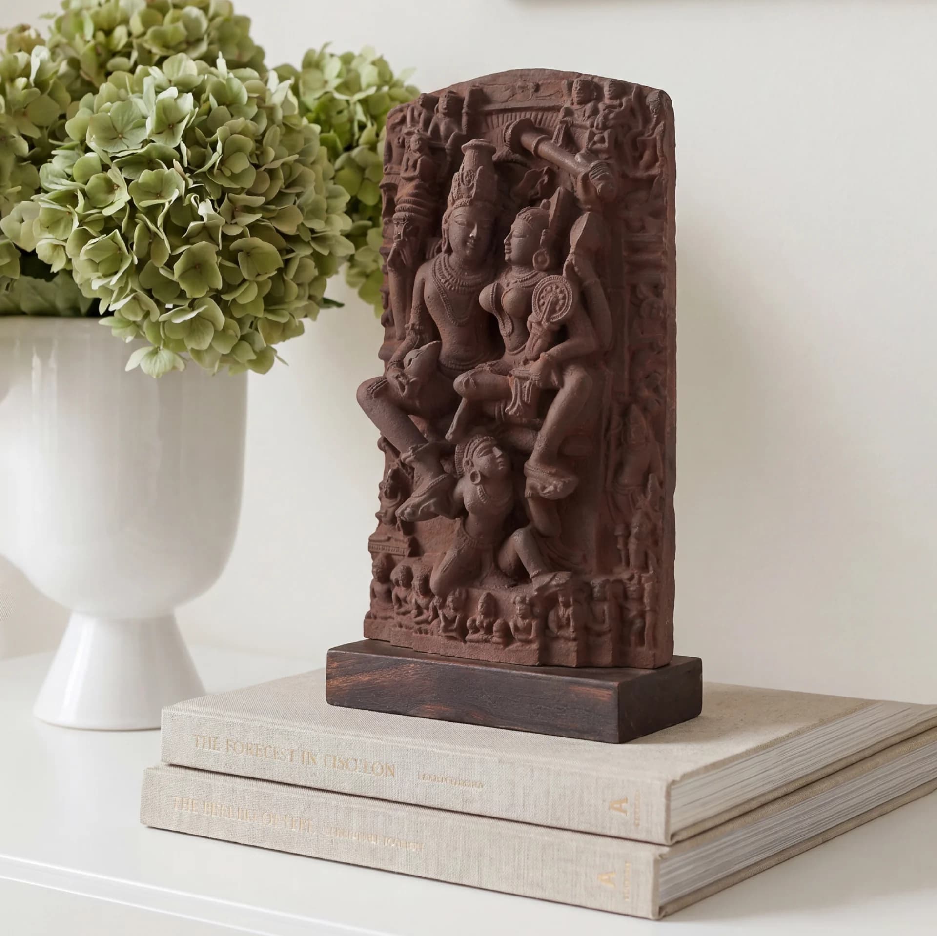 A detailed three-quarter view of the Lakshmi Narayan Sculpture, featuring intricate sandstone-style carvings of the divine couple on a dark base.