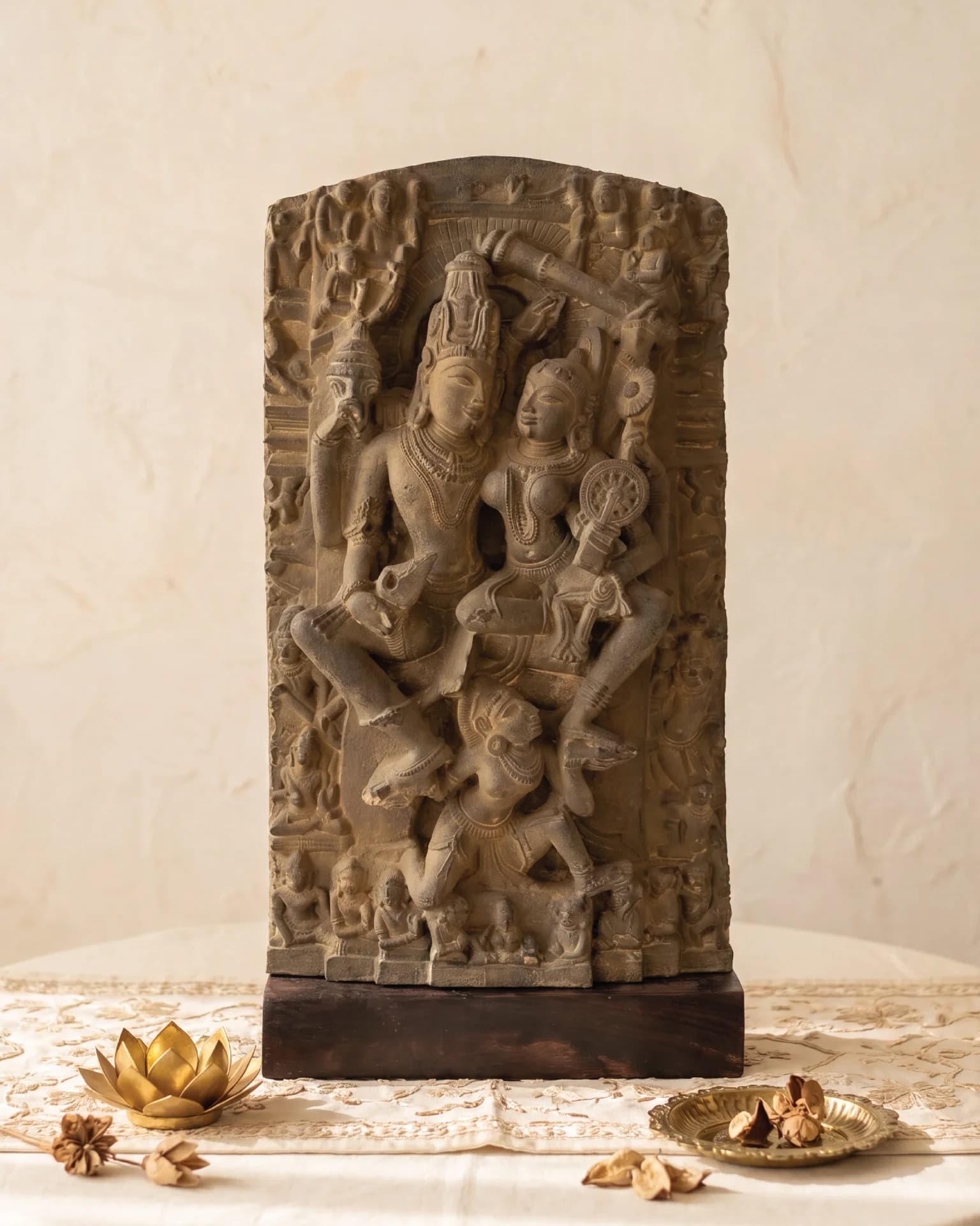 A front-facing view of the Lakshmi Narayan Sculpture, a stone composite replica featuring detailed carvings of deities seated on Garuda.