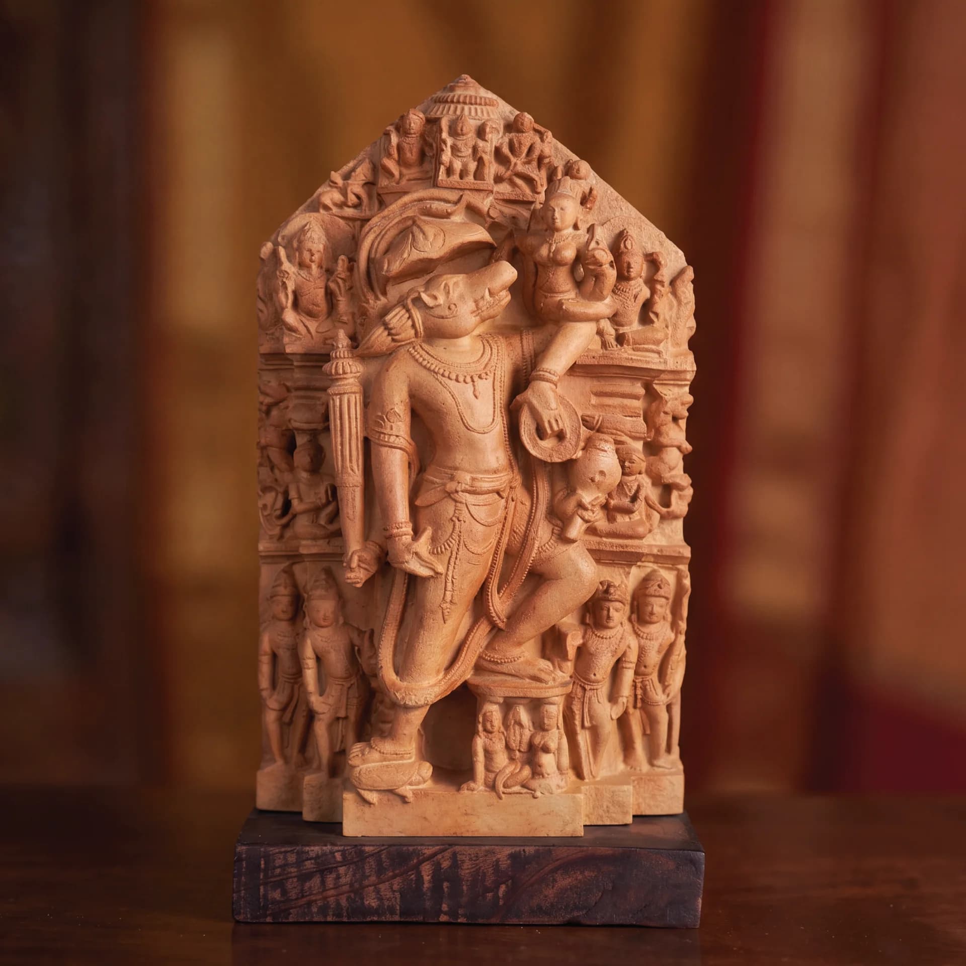 A front-facing view of the Nar Varaha Sculpture, a hand-finished stone composite replica featuring intricate temple art carvings.