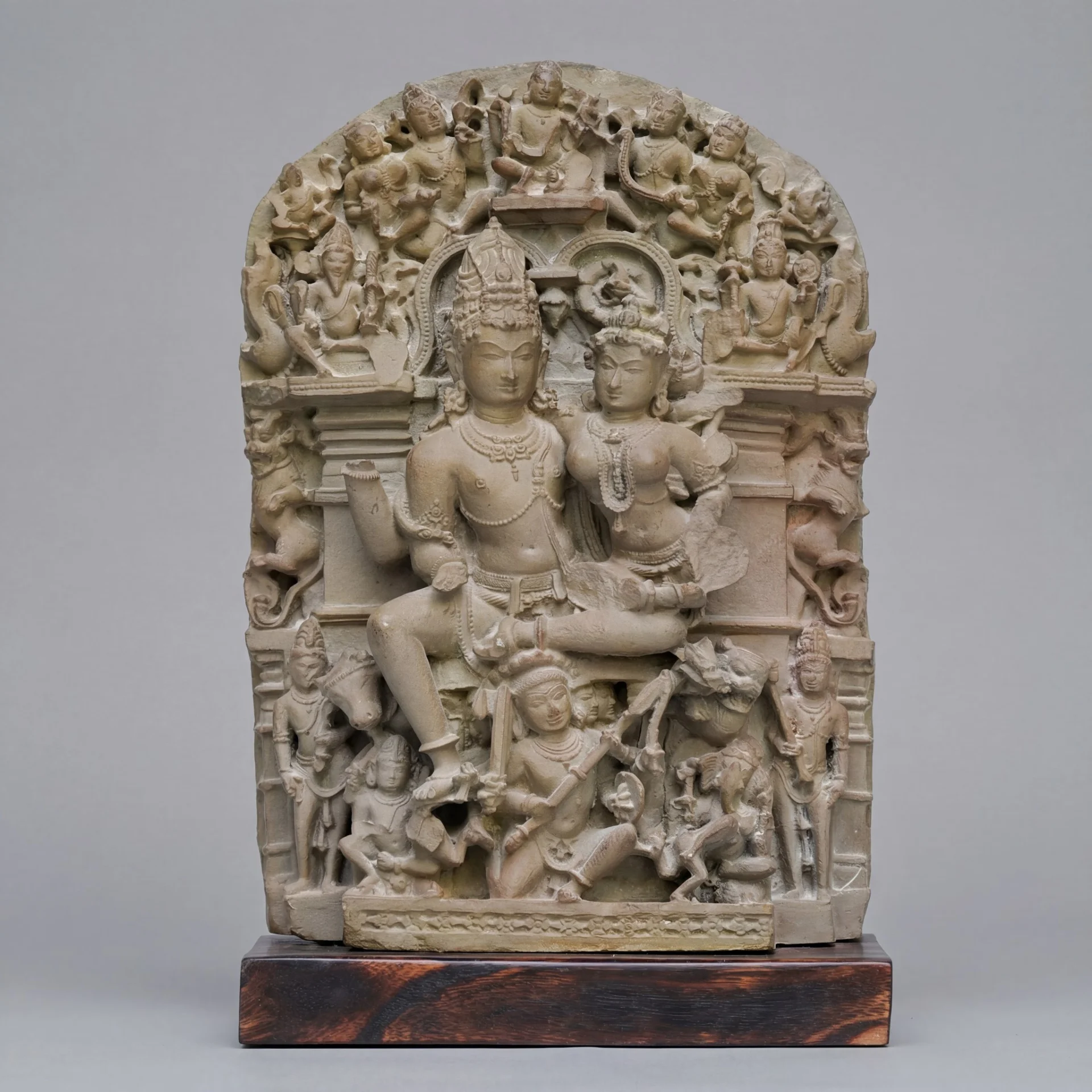 A front-facing view of the stone composite Ravananugraha Sculpture showing intricate 11th-century style carvings of Shiva and Ravana.