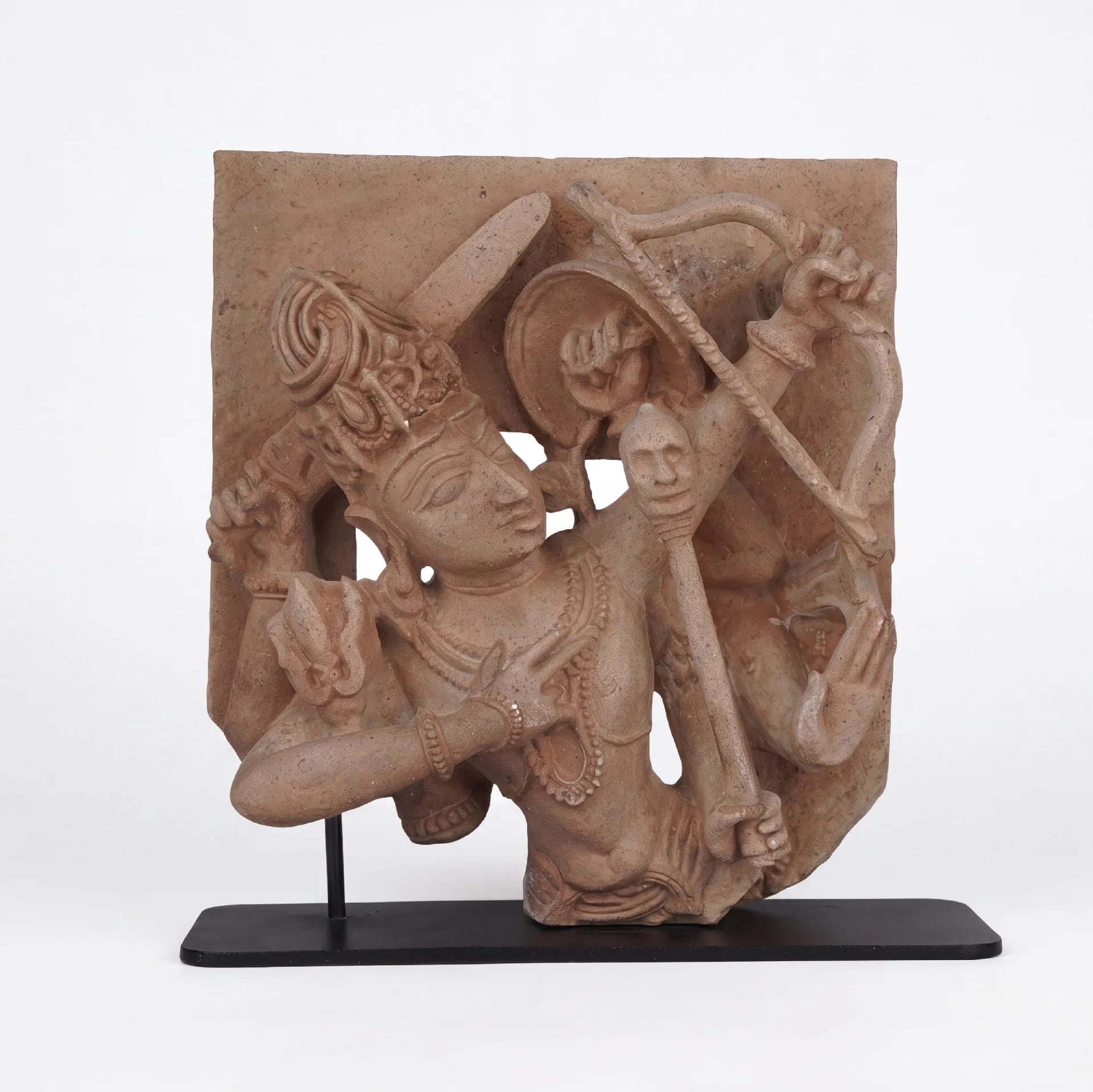 A front-facing view of the Tripurantaka Shiva stone composite sculpture, showing the deity holding a bow and arrow.